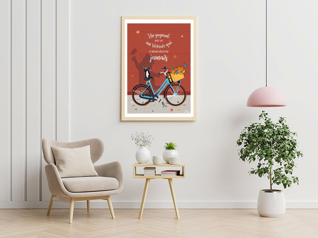 Affiche encadrée, chat sur vélo bleu et fleurs, citation manuscrite sur fond rouge.